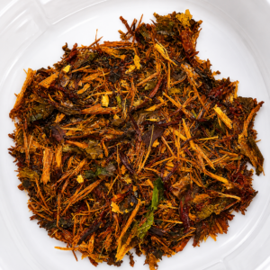 Premium loose herbal smoking blend containing shredded aromatic botanicals inside a clear container